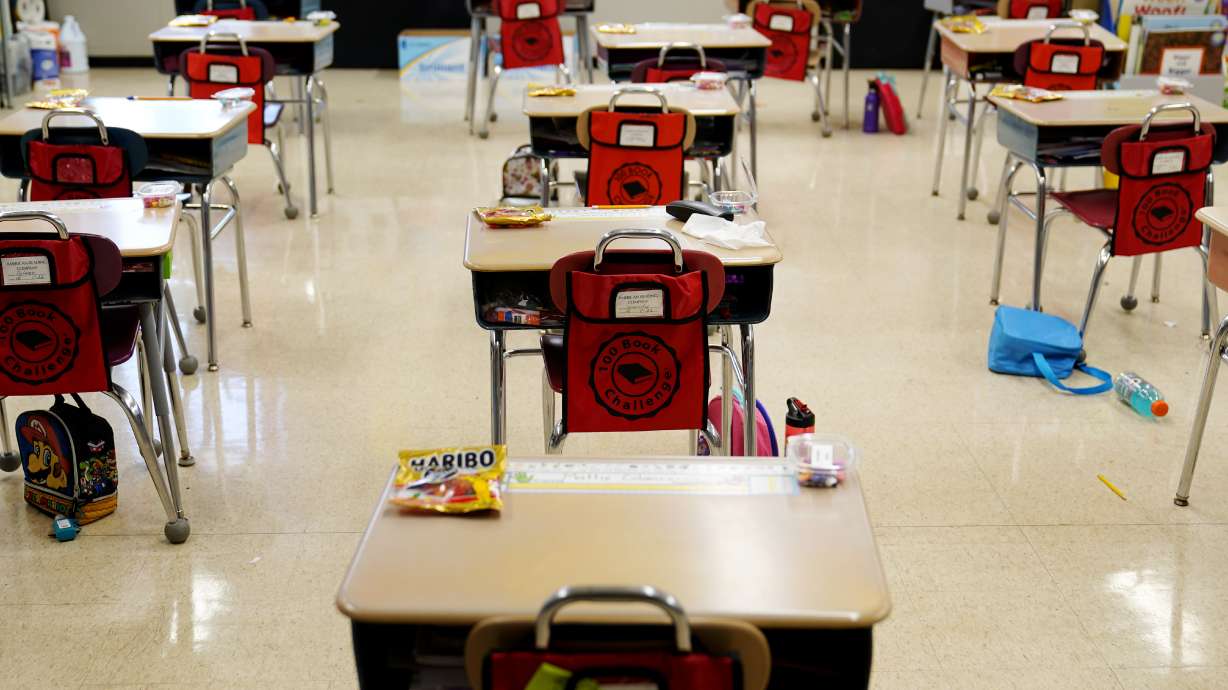 In this Thursday, March 11, 2021 file photo, desks are arranged in a classroom at an elementary school in Nesquehoning, Pa. In the fall of 2021, vaccinated teachers and students should no longer wear masks inside school buildings and no one need bother with them outside, the Centers for Disease Control and Prevention said Friday, July 9, 2021.