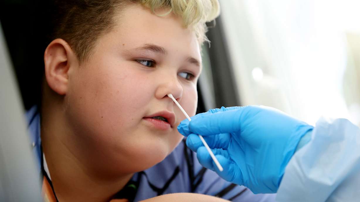 Isaac Kelly receives a COVID-19 test from Eric Kwiatkowski, with the Utah National Guard's Forward Support Company in St. George, at the Utah State Fairpark in Salt Lake City on Tuesday, July 6, 2021. Utah reported 655 new COVID-19 cases on Friday.