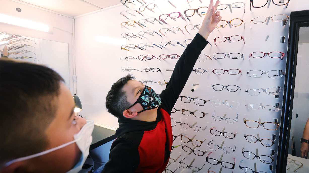 Santi Morales, 9, picks out eyeglass frames as Eye Care 4 Kids and its mobile clinic visit the Lied Boys and Girls Club in Glendale on Friday, July 9, 2021. Santi is the 400,000th child to be helped by the organization.