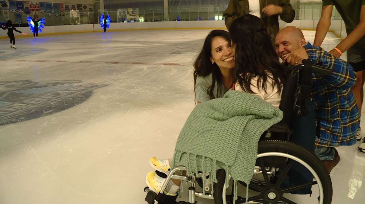 Claudia and Nelson Mousques share a moment with their 14-year-old daughter, Sophia Mousques. They were surprised to see her crying after watching the ice skaters. At first they were worried she was in pain, but Sophia told them she was happy.