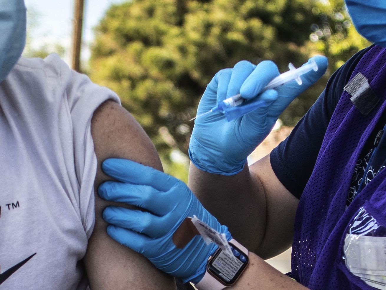 Freddy Centeno, left, receives a COVID-19 vaccine from
health care worker Danielle Davis, right, at pop-up vaccination
event at Reams in Magna on Monday, May 3, 2021. With COVID-19 cases
surging in Utah, is it time for booster shots for the fully
vaccinated?
