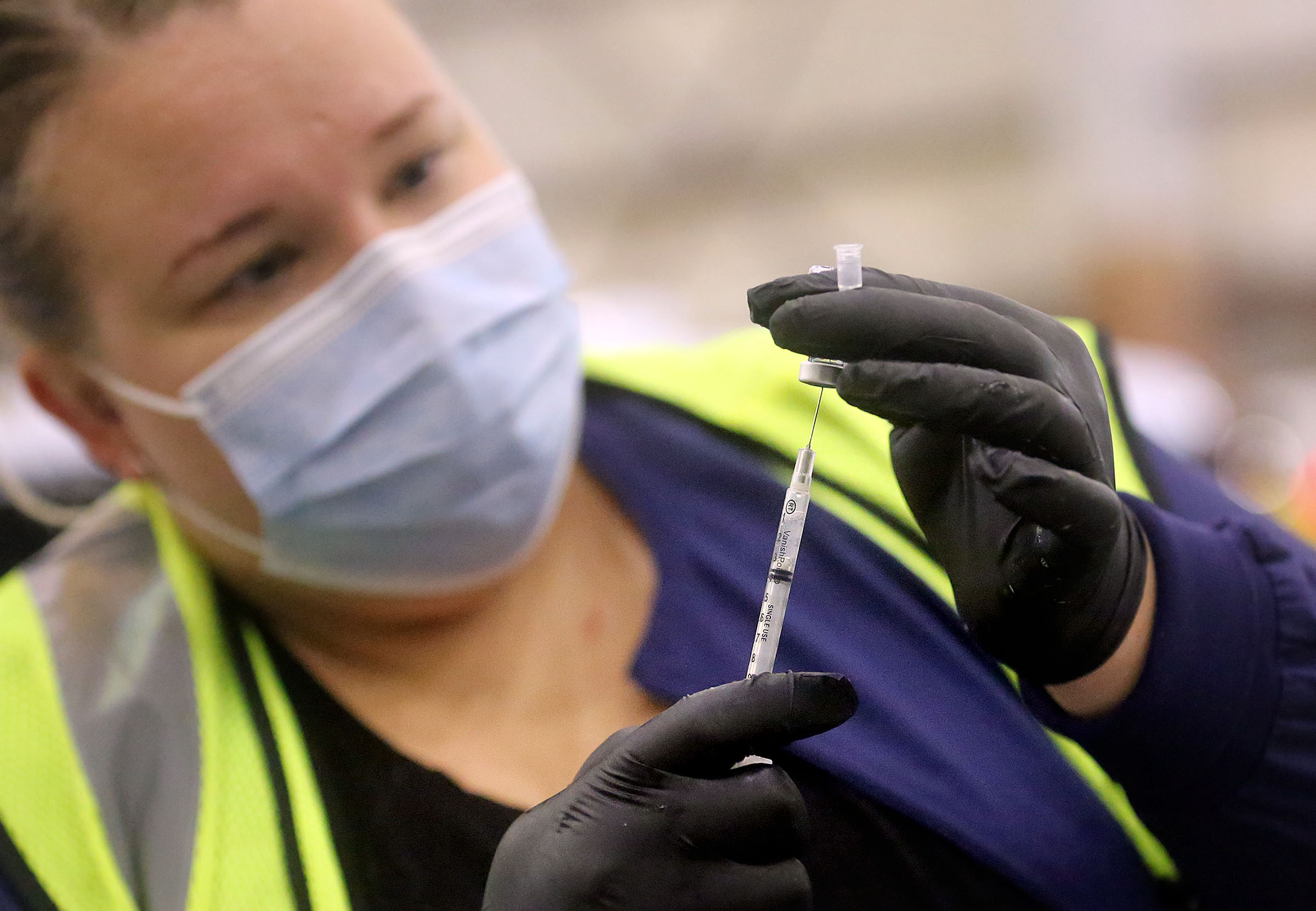 Aimee Koryta, a Davis County Health Department registered nurse, prepares a syringe of Pfizer-BioNTech COVID-19 vaccine at the Legacy Center Indoor Arena in Farmington on Jan. 12. The Utah Department of Health reported 2,244 more COVID-19 cases, 15 deaths and 18,134 vaccinations on Monday.