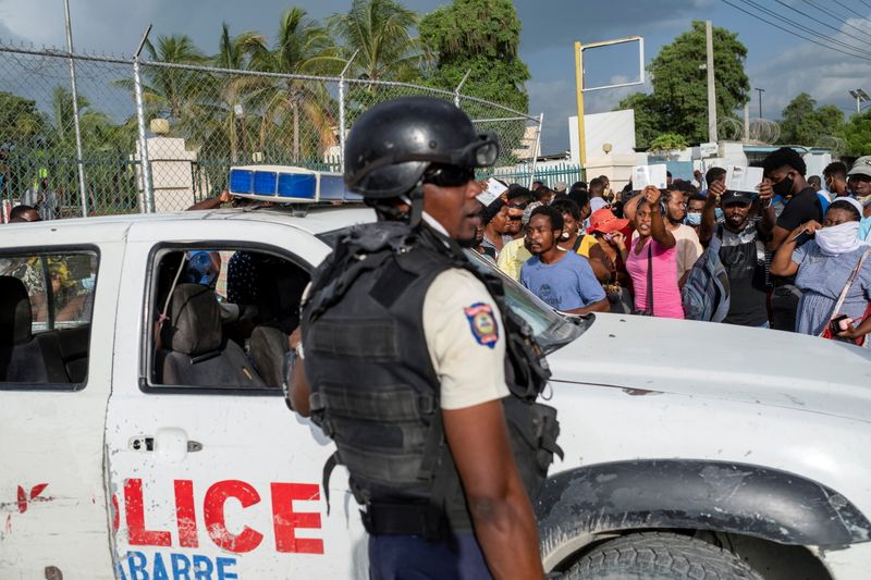 Haitian National Policemen guard the entrance to the U.S. Embassy as people gather to ask for asylum following the assassination of President Jovenel Moise, in Port-au-Prince, Haiti July 9, 2021.