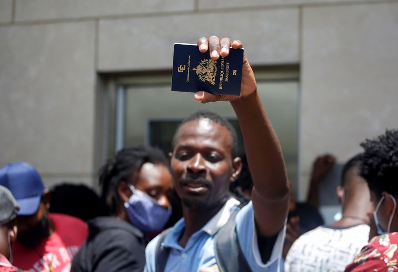 A Haitian man shows his passport outside the U.S. Embassy after the assassination of President Jovenel Moise, in Port-au-Prince, Haiti July 9, 2021.