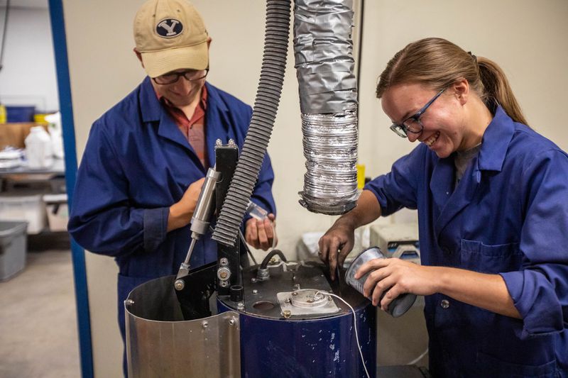 BYU undergraduate student Ethan Ostraff, left, and
graduate student Amber Johnson, right, work with activated carbon
to cover seeds in a lab on the BYU campus in Provo on June 25,
2021.