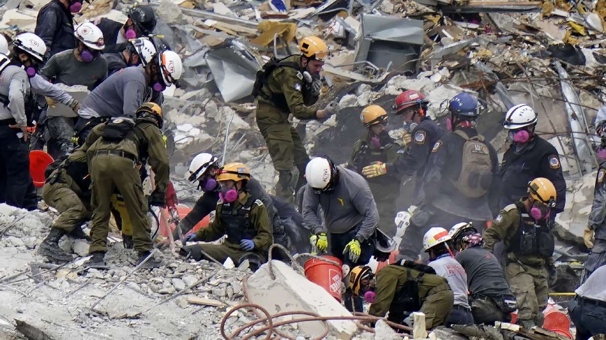 FILE - Crews from the United States and Israel work in the rubble Champlain Towers South condo, Tuesday, June 29, 2021, in Surfside, Fla. The Israeli search and rescue team that arrived in South Florida shortly after the Champlain Towers South collapsed last month is heading home after an emotional sendoff in Surfside. The team planned to leave Florida on Sunday, July 11. During a brief Saturday evening ceremony, Miami-Dade Mayor Daniella Levine Cava thanked the battalion for their “unrelenting dedication."