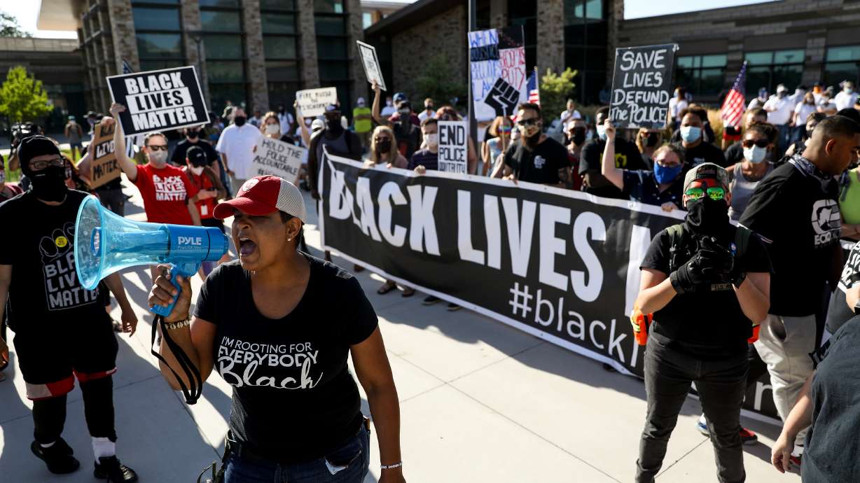 Lex Scott, founder of Black Lives Matter Utah, leads a chant during a protest in Cottonwood Heights on Aug. 7, 2020. The president of the Utah NAACP chapter has denounced Scott's controversial statement that the American flag is a symbol of hatred and racism.