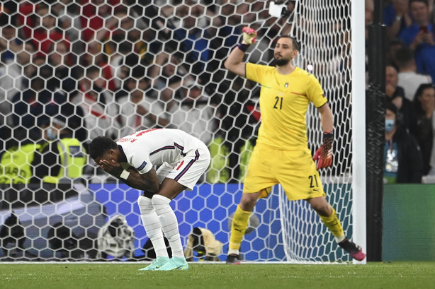 England's Marcus Rashford reacts after missed a penalty shot during the penalty shootout during the Euro 2020 soccer final match between England and Italy at Wembley stadium in London, Sunday, July 11, 2021.