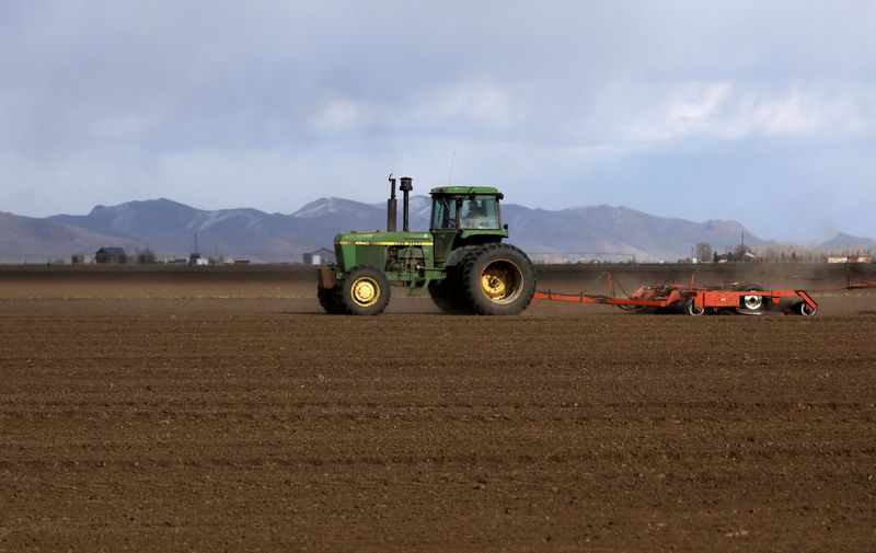 A farmer plows a field with a tractor amid concerns related to coronavirus disease near the town of Bellevue in Blaine County, Idaho, April 13, 2020. An unprecedented heat wave and ongoing drought in the U.S. Pacific Northwest is damaging white wheat coveted by Asian buyers and forcing fruit farm workers to harvest in the middle of the night. 