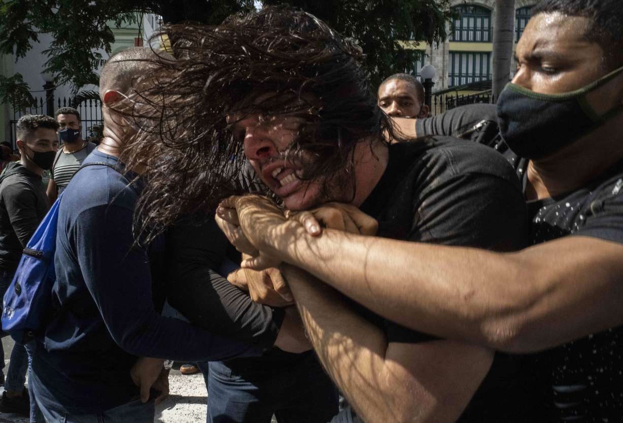 Plainclothes police detain an anti-government protester during a protest in Havana, Cuba, Sunday, July 11, 2021. Hundreds of demonstrators went out to the streets in several cities in Cuba to protest against ongoing food shortages amid the new coronavirus crisis.