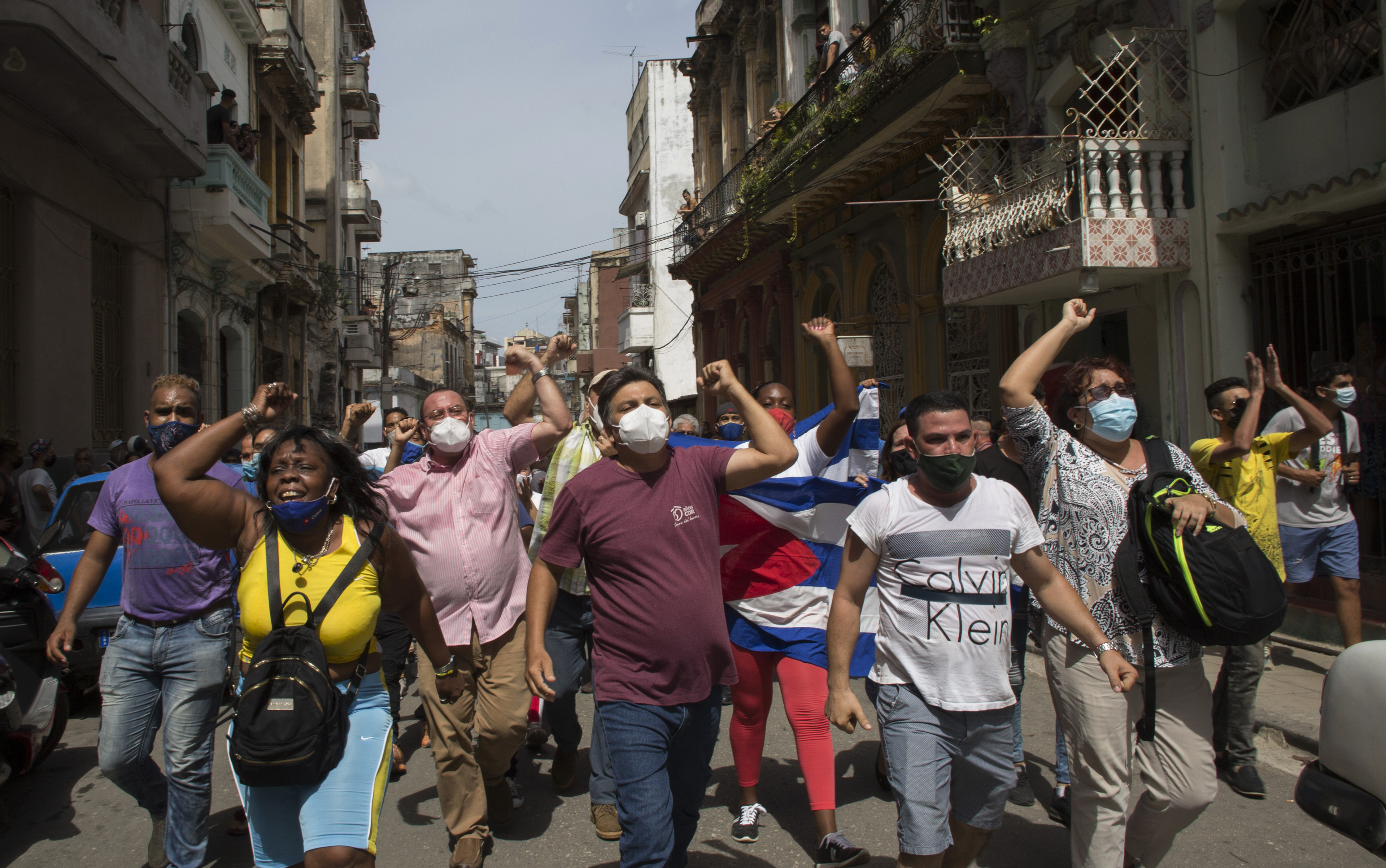 Government supporters shout slogans as anti-government protesters march in Havana, Cuba, Sunday, July 11, 2021. Hundreds of demonstrators went out to the streets in Cuba to protest against ongoing food shortages.
