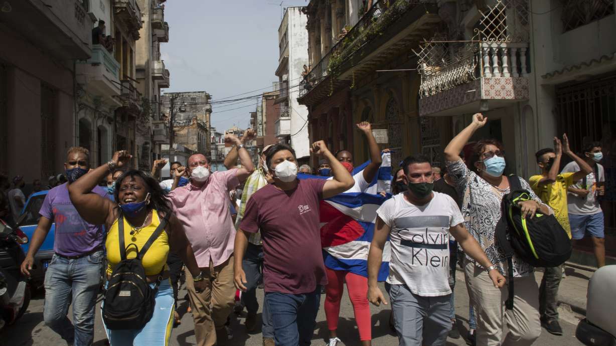 Government supporters shout slogans as anti-government protesters march in Havana, Cuba, Sunday, July 11, 2021. Hundreds of demonstrators went out to the streets in Cuba to protest against ongoing food shortages.