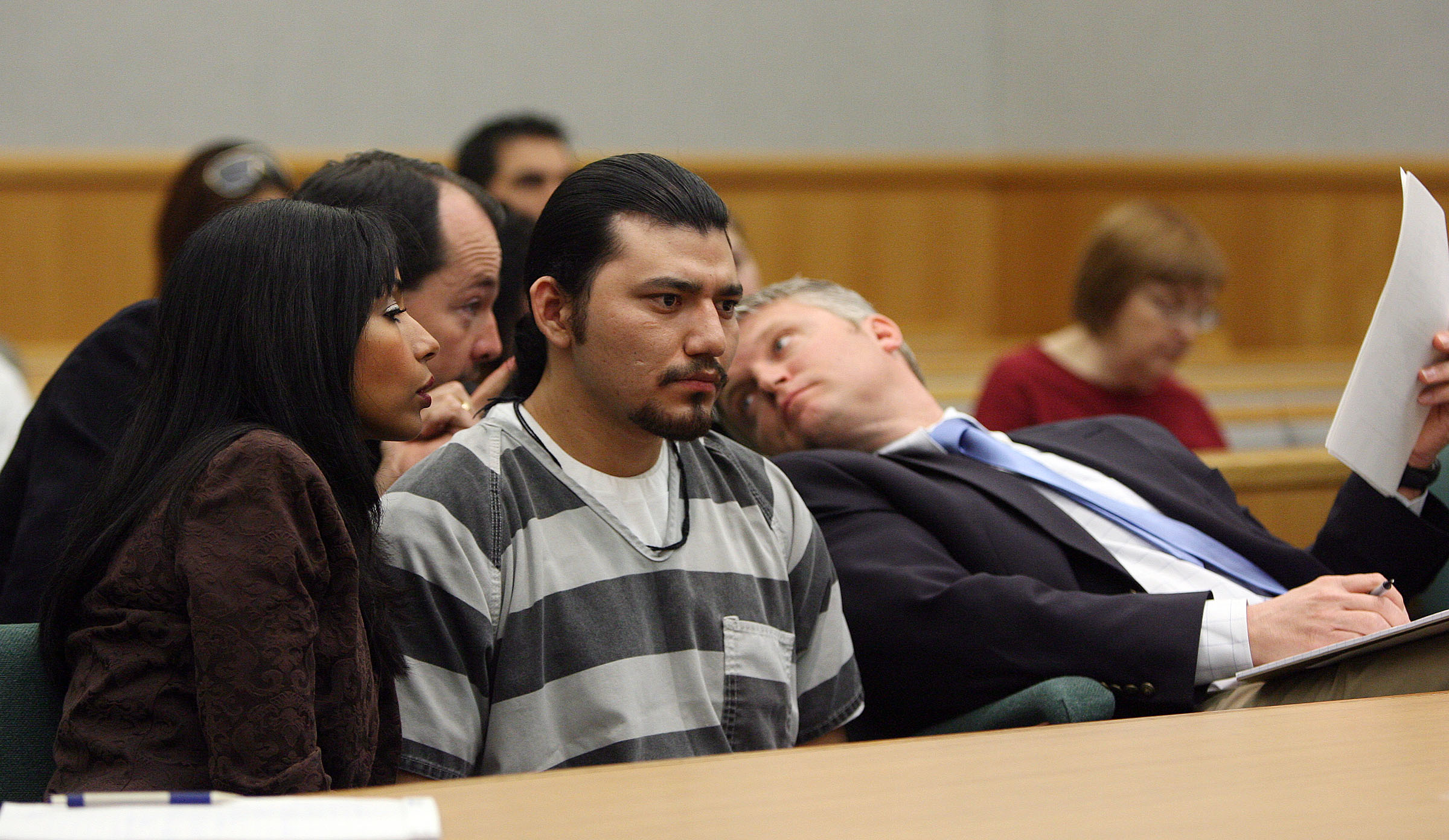 Defense attorneys Scott Williams, right, and Brook Sessions talk around Cunny Pelaez during sentencing in 4th District Court in Heber City on March 7, 2007, after being convicted of murder in the shooting death of Aniceto Armendariz. Pelaez recently had his first parole hearing, but he claimed he couldn't remember much about his crime.