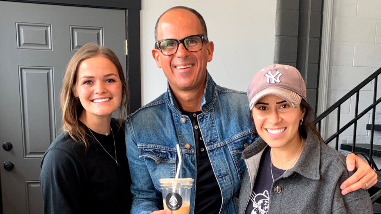 Roots Coffee & Co. co-owners McKenzie Packard, left, and Ginalen Soto, right, pose with celebrity entrepreneur Marcus Lemonis. Packard and Soto received $10,000 from Lemonis's Lemon-AID Foundation to offer more opportunities to small businesses and underserved communities. They will use the money to open a second location near Spanish Fork.