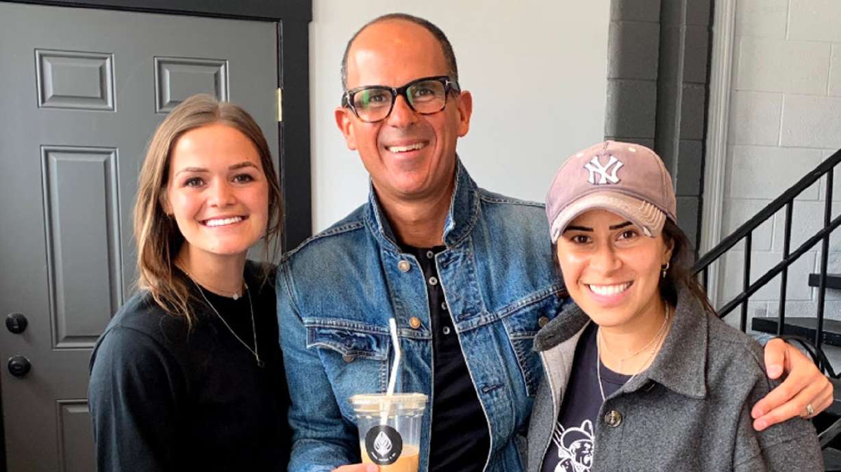 Roots Coffee & Co. co-owners McKenzie Packard, left, and Ginalen Soto, right, pose with celebrity entrepreneur Marcus Lemonis. Packard and Soto received $10,000 from Lemonis's Lemon-AID Foundation to offer more opportunities to small businesses and underserved communities. They will use the money to open a second location near Spanish Fork.