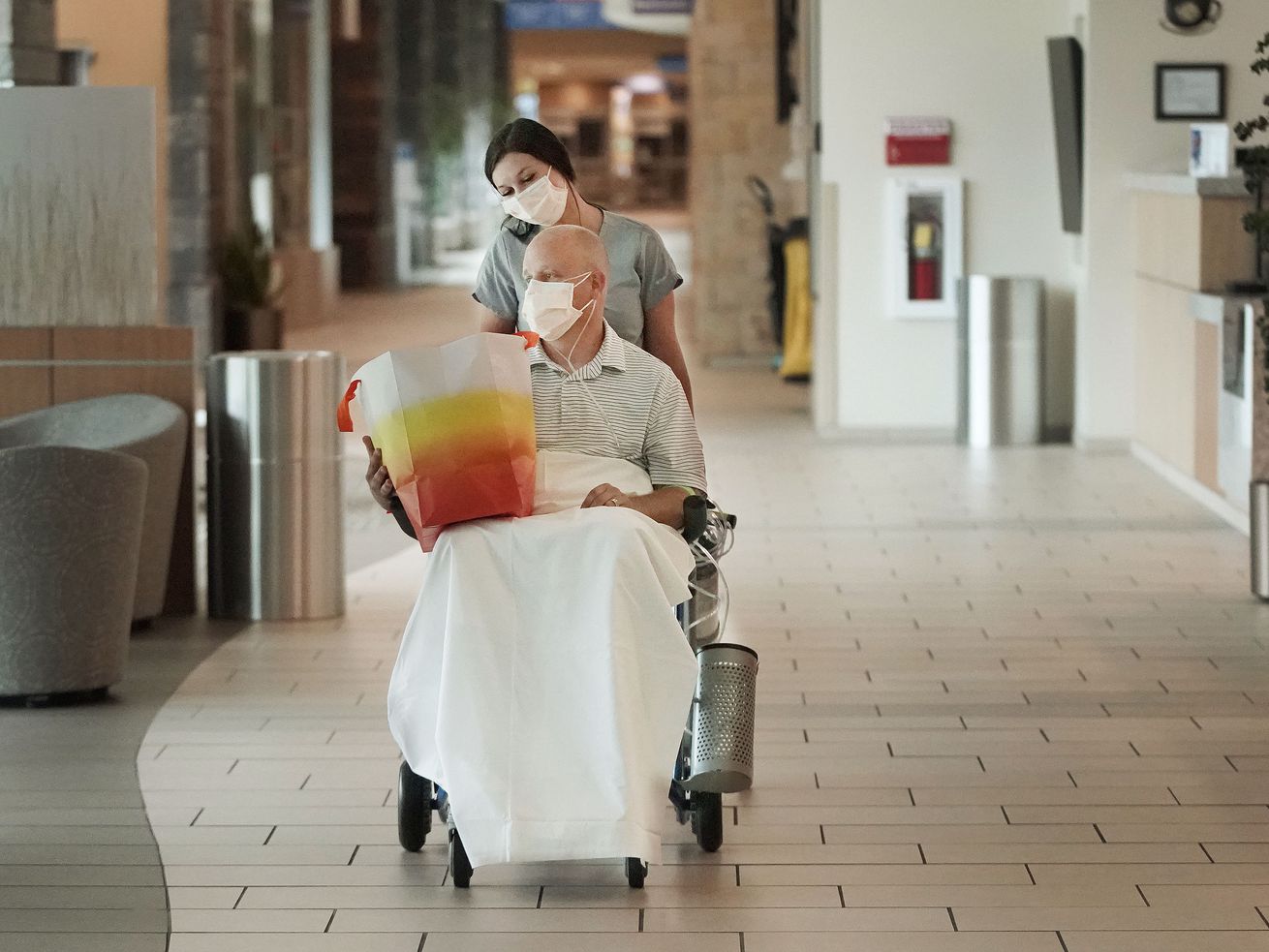 Nurse practitioner Aaron Hartle is wheeled out of Utah Valley Hospital by Haley Dunn after being released in Provo on
Sunday, July 11, 2021. Hartle was hospitalized with COVID-19 after turning down the vaccine and now wants to urge others to get the shots.