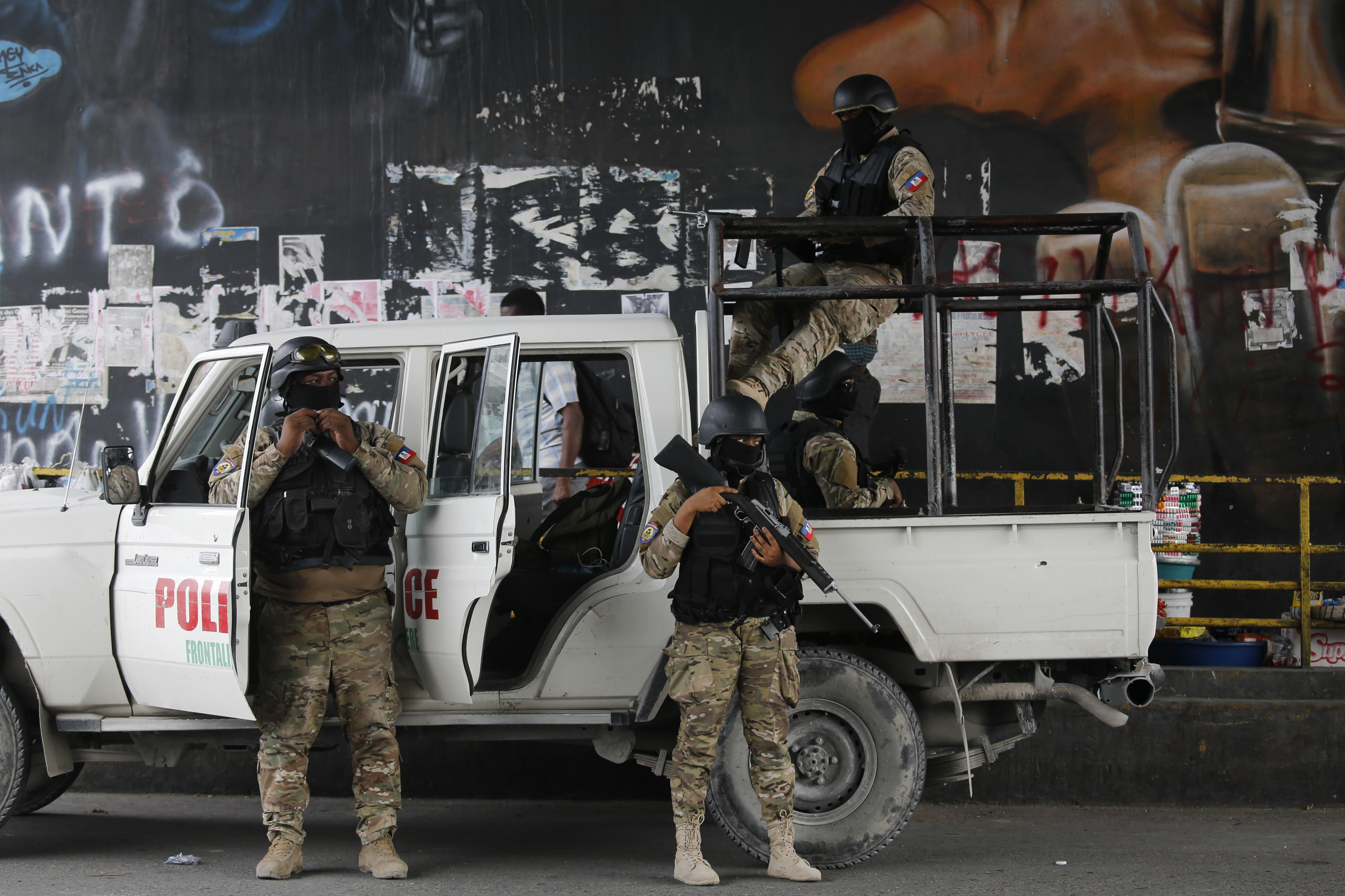 Police stand guard under an overpass in Port-au-Prince, Haiti, Monday, July 12, 2021. President Jovenel Moise was assassinated on July 7. 