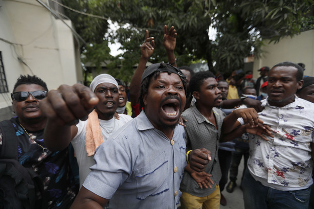 Supporters of former Senator Steven Benoit shout outside the courthouse as he departs after being called in for questioning, in Port-au-Prince, Monday, July 12, 2021.