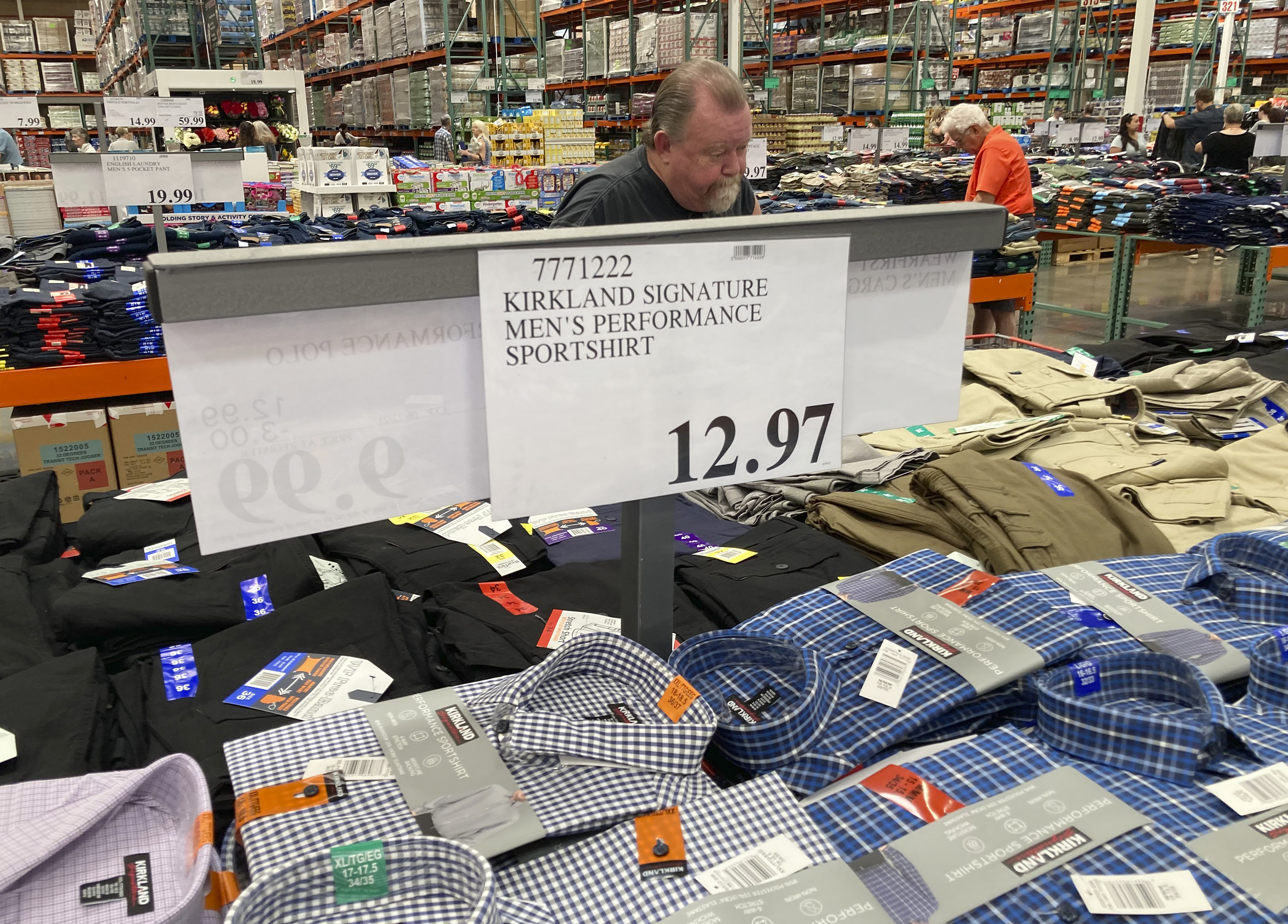A sign displays the price for shirts at a Costco warehouse on June 17, 2021, in Lone Tree, Colo. American consumers faced a third straight monthly surge in princes in June.