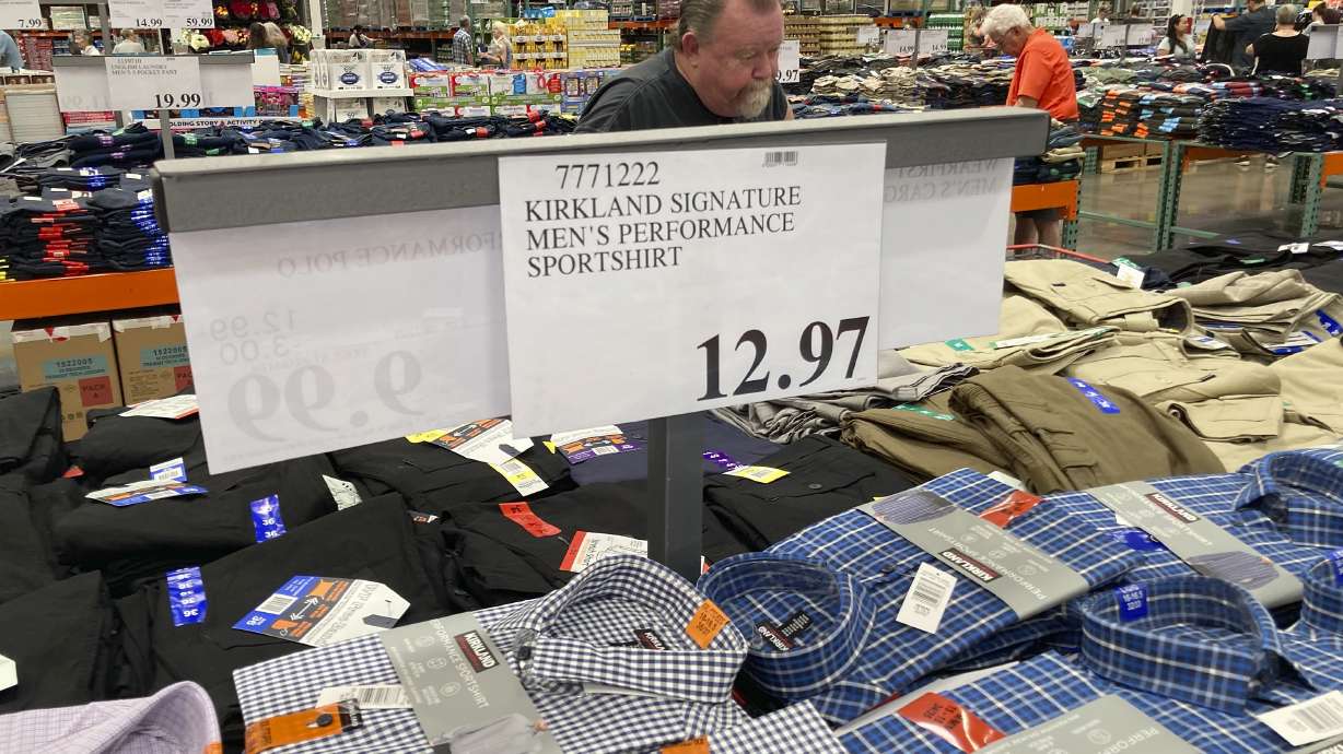 A sign displays the price for shirts at a Costco warehouse on June 17, 2021, in Lone Tree, Colo. American consumers faced a third straight monthly surge in princes in June.