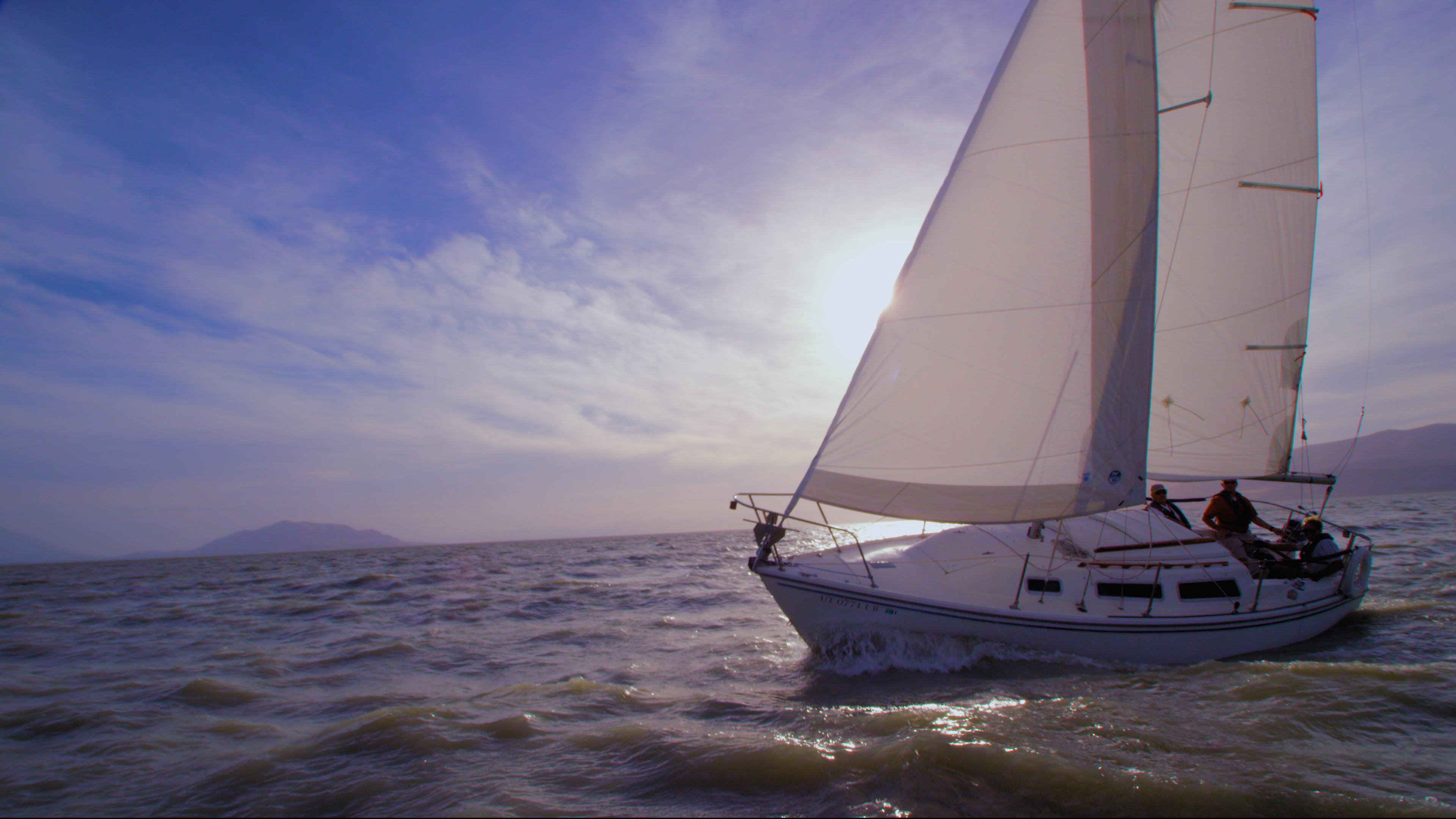A sailboat cuts through the waves on Utah Lake.