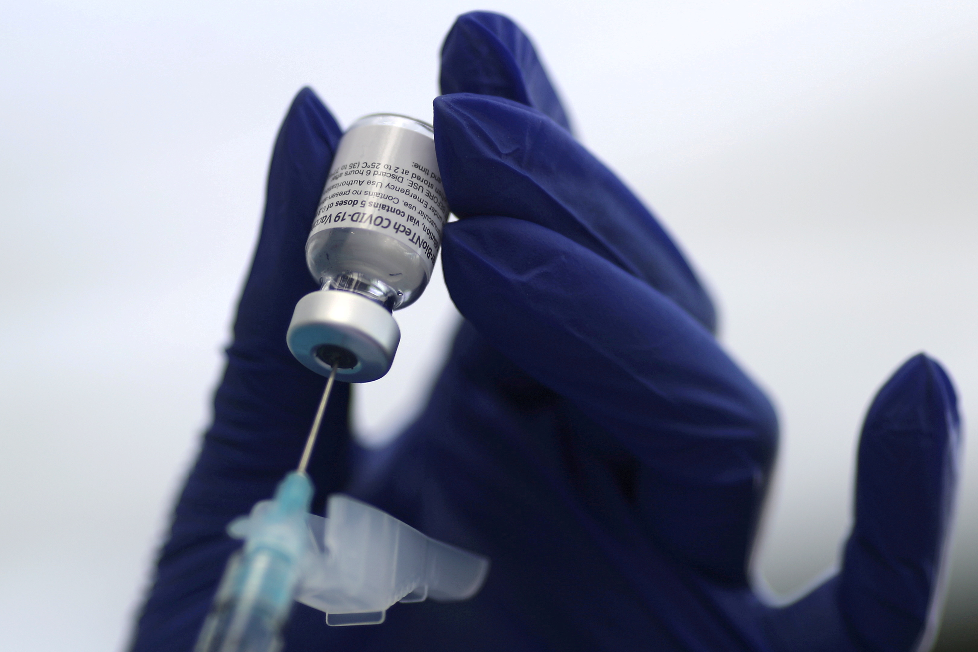 A health care worker prepares a Pfizer coronavirus disease vaccination in Los Angeles, California, Jan. 7, 2021.