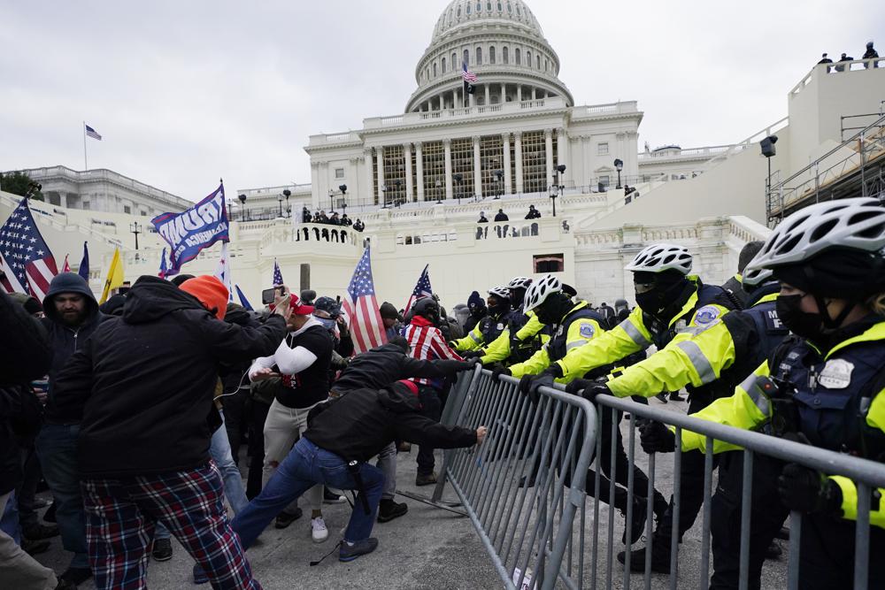 In this Jan. 6, 2021 file photo, supporters loyal to then-President Donald Trump, try to break through a police barrier at the Capitol in Washington. Key figures in the Jan. 6 riot on U.S. Capitol spoke about their desire to overthrow the government, but to date, U.S prosecutors have charged no one with sedition. They could still add them. But prosecutors may be reluctant to bring them because of their legal complexity and the difficulty in securing convictions.