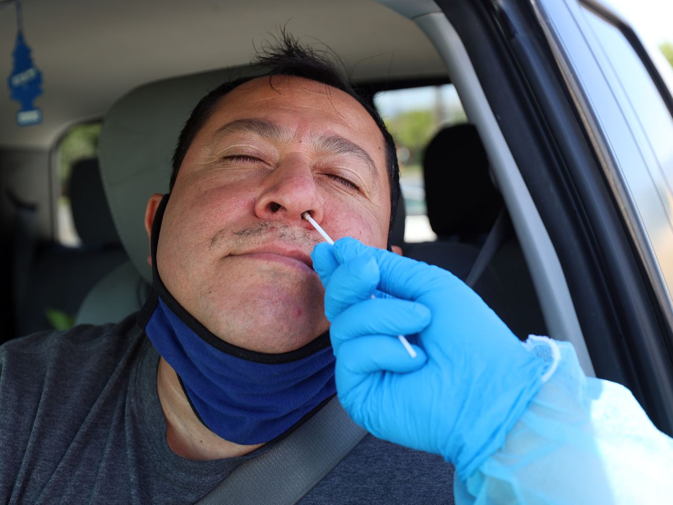 Utah National Guard Staff Sgt. Sorensen gives Ramiro Zavala a COVID-19 test at the Maverik Center in
West Valley City on Tuesday, July 6, 2021.