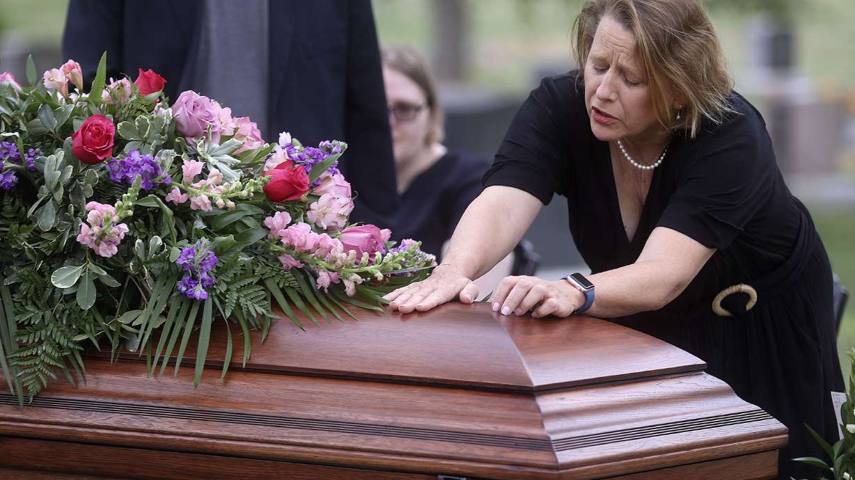 Tricia Wright grieves over the casket of her sister, Shawna Wright, who died of heat exhaustion while homeless, during Shawna Wright's interment at Mount Olivet Cemetery in Salt Lake City on Tuesday, July 13, 2021.