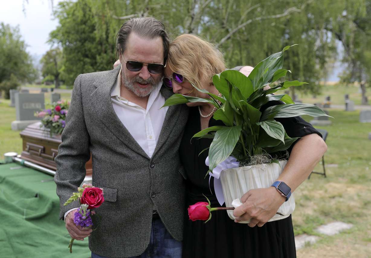 Alan E. Wright and Tricia Wright hug after the interment for their sister, Shawna Wright, who died of heat exhaustion while homeless, at Mount Olivet Cemetery in Salt Lake City on Tuesday, July 13, 2021.