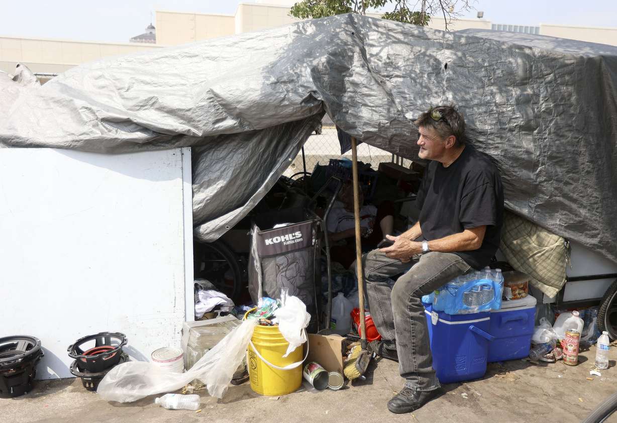 Robert Malloy, who is homeless, rests by a friend’s shade structure during a heat wave in Salt Lake City on Monday, July 12, 2021.