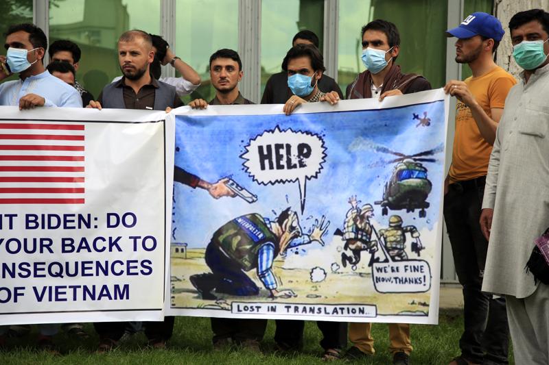 Former Afghan interpreters hold banners during a protest against the U.S. government and NATO in Kabul, Afghanistan, on April 30, 2021. The Biden administration is set to begin evacuations of Afghan interpreters and translators who aided the U.S. military effort in the nearly 20-year war, an administration official said.