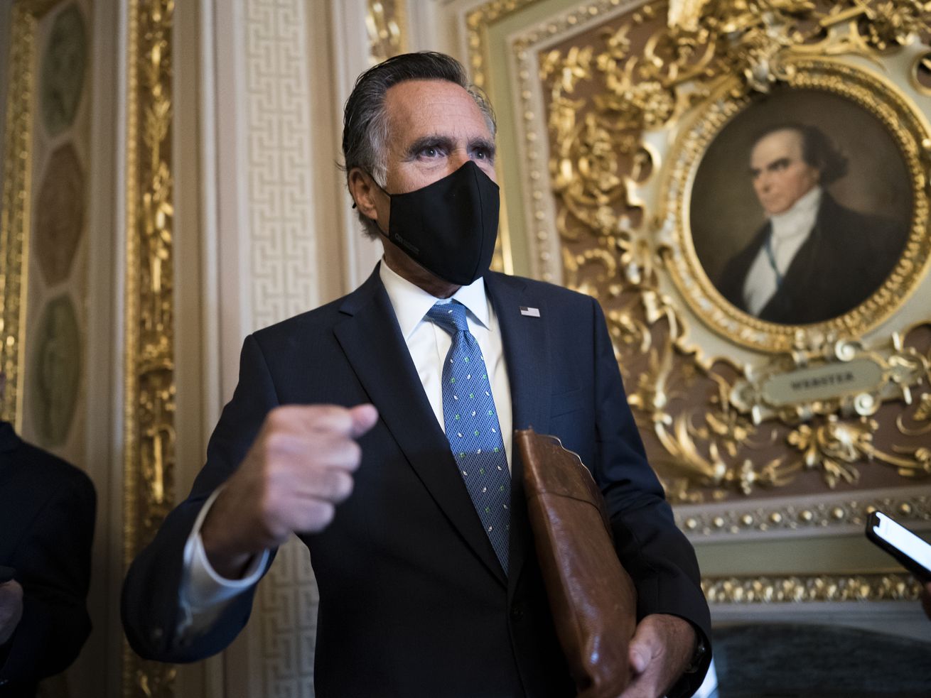 Sen. Mitt Romney, R-Utah, pauses to answer questions from reporters at the Capitol in Washington, Tuesday, Feb. 23, 2021.