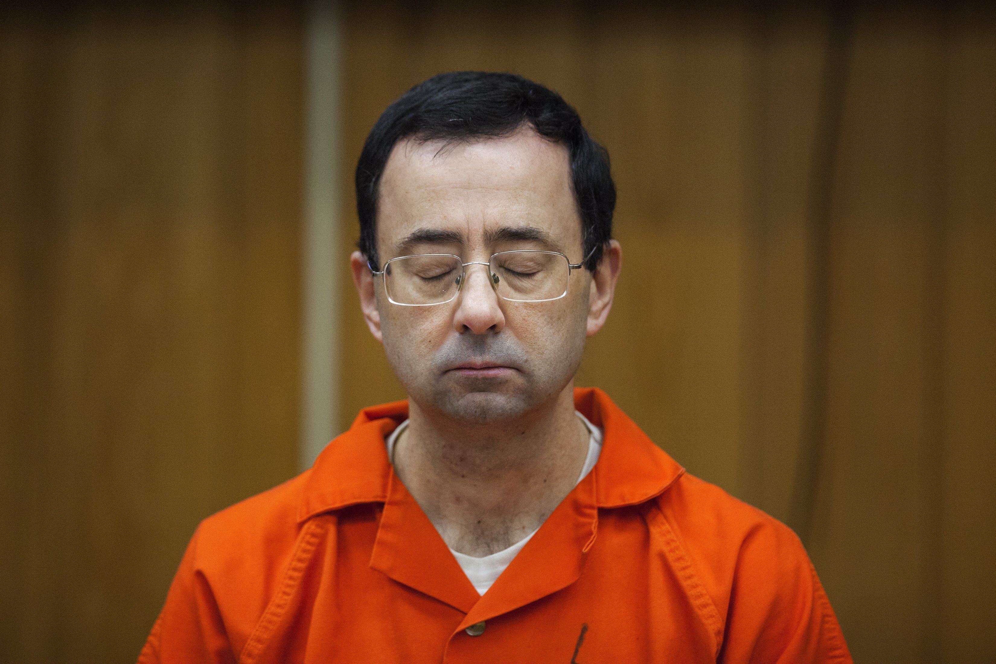 In this Feb. 5, 2018 photo, Larry Nassar listens during his sentencing at Eaton County Circuit Court in Charlotte, Mich. A new report released Wednesday, July 14, 2021, found the FBI mishandled the Nassar-USA Gymnastics case.