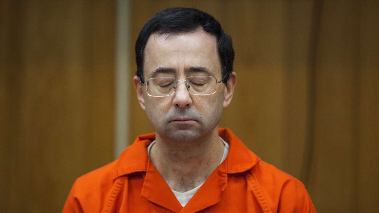 In this Feb. 5, 2018 photo, Larry Nassar listens during his sentencing at Eaton County Circuit Court in Charlotte, Mich. A new report released Wednesday, July 14, 2021, found the FBI mishandled the Nassar-USA Gymnastics case.