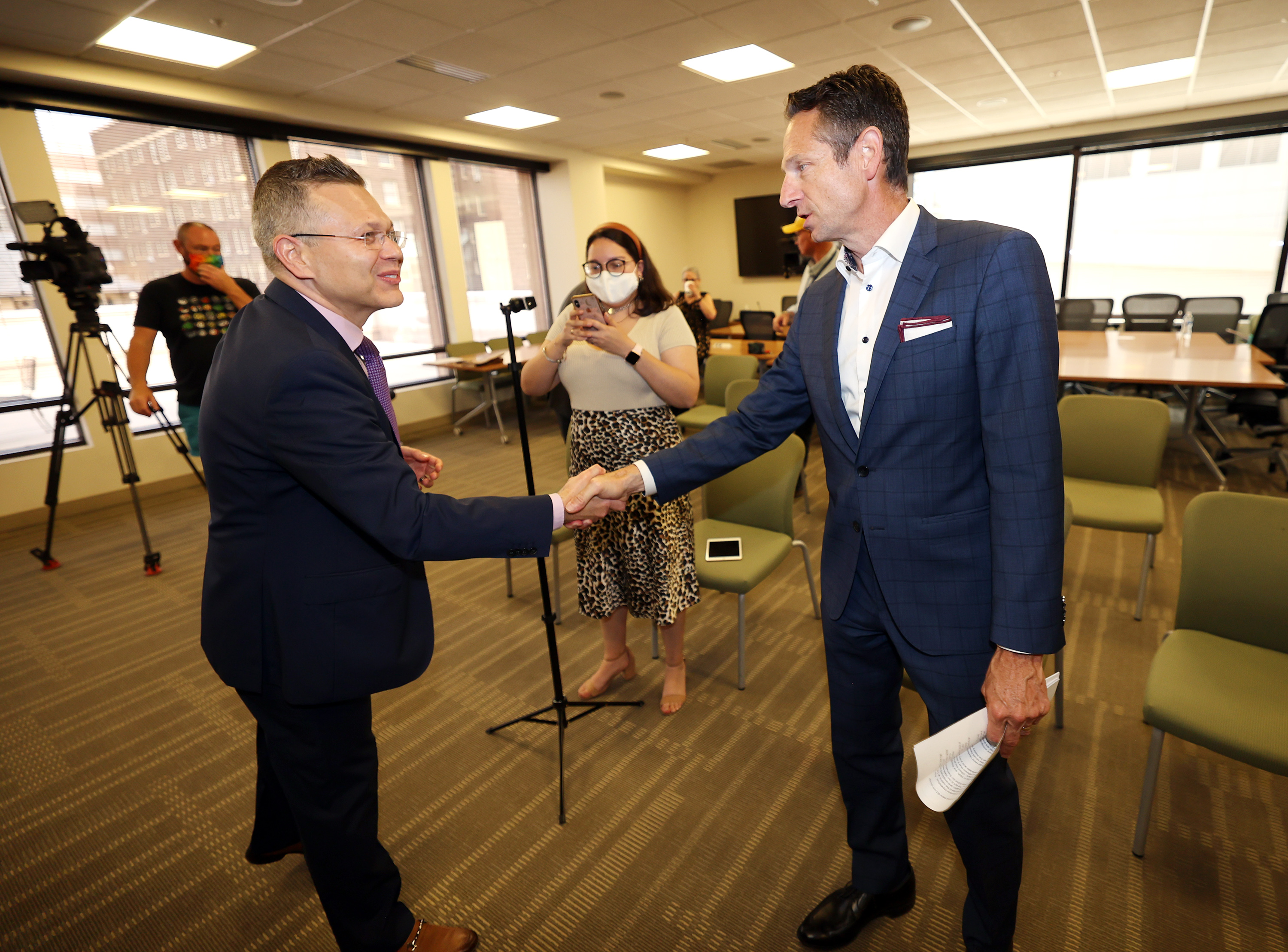 Mikhail Shneyder, president and CEO of Nightingale College, left, shakes hands with Derek Miller, president and CEO of the Salt Lake Chamber of Commerce, after a news conference at the World Trade Center Utah offices in Salt Lake City on Wednesday, July 14, 2021, where they called on Utah's senators to support bipartisan immigration reform. They were joined by representatives of the Intermountain chapter of the American Business Immigration Coalition, New American Economy, the Salt Lake Area Restaurant Association and Mormon Women for Ethical Government.