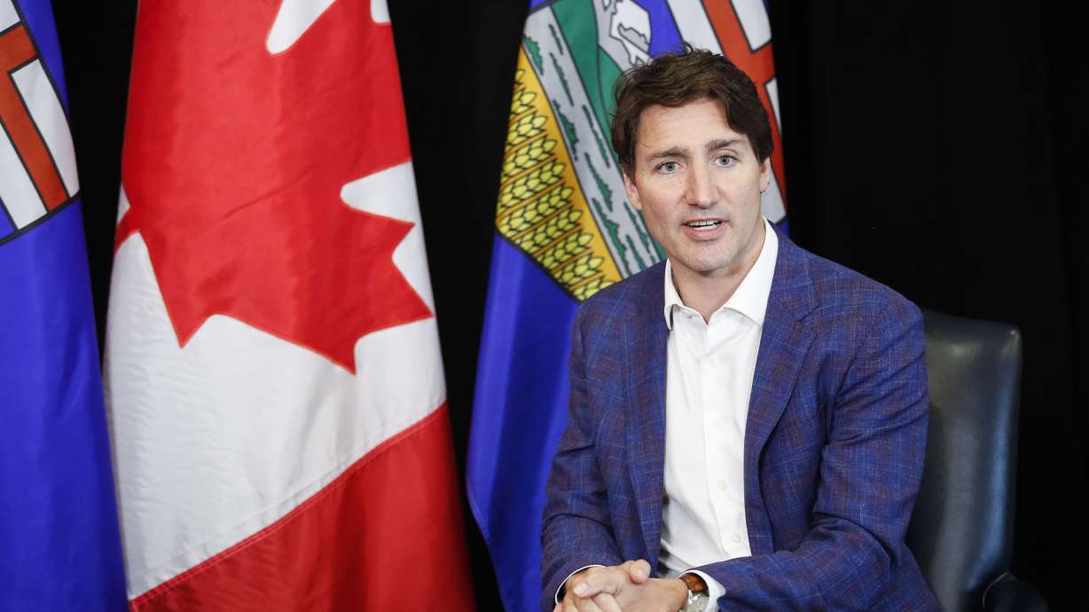 Canadian Prime Minister Justin Trudeau speaks as he meets with Alberta Premier Jason Kenney in Calgary, Alberta, Wednesday, July 7, 2021. On Thursday, he announced fully vaccinated Americans will be welcomed starting in mid-August.