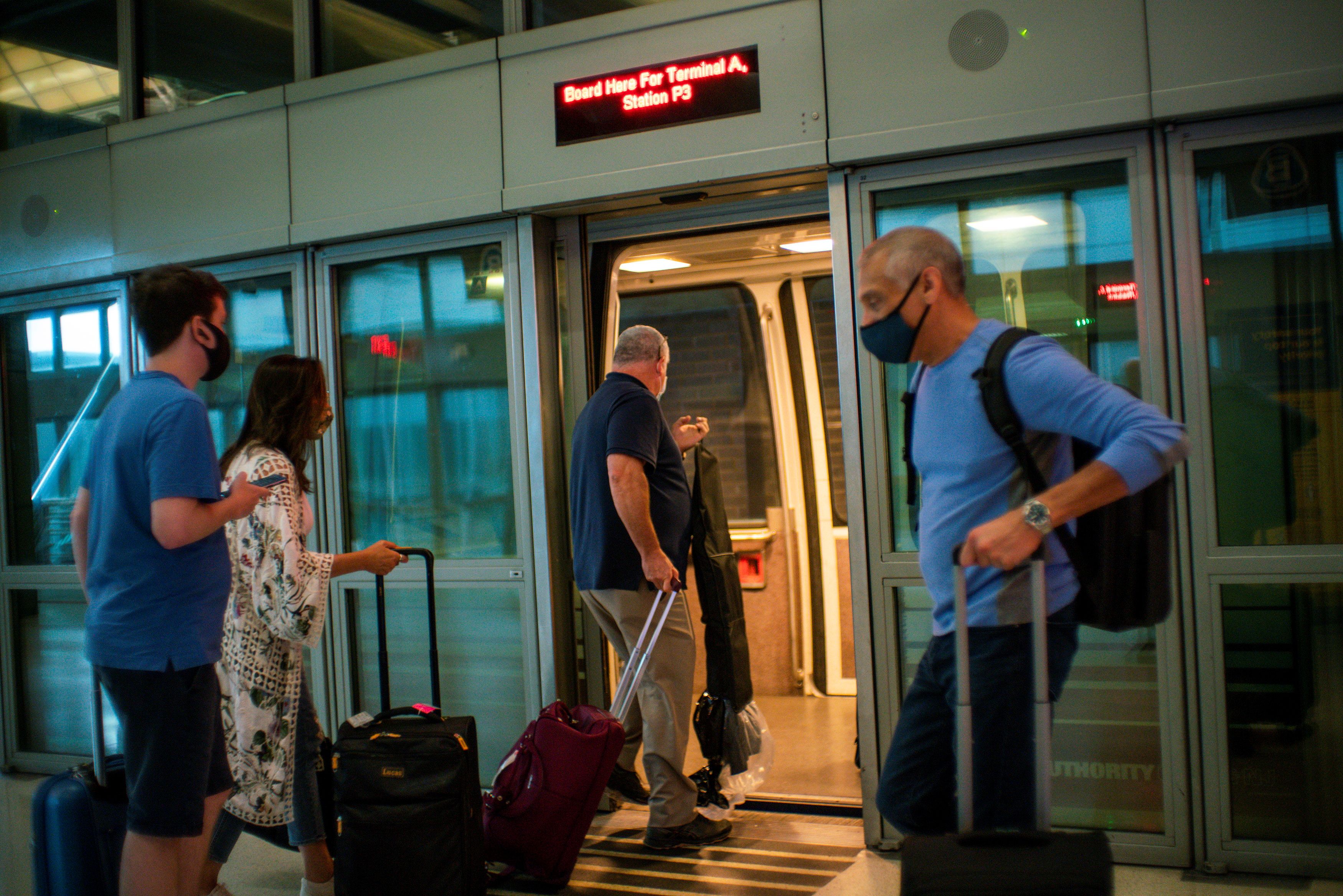 Travelers board the air train ahead of the July 4th holiday, at the Newark Liberty International Airport, in Newark, New Jersey, July 2, 2021.