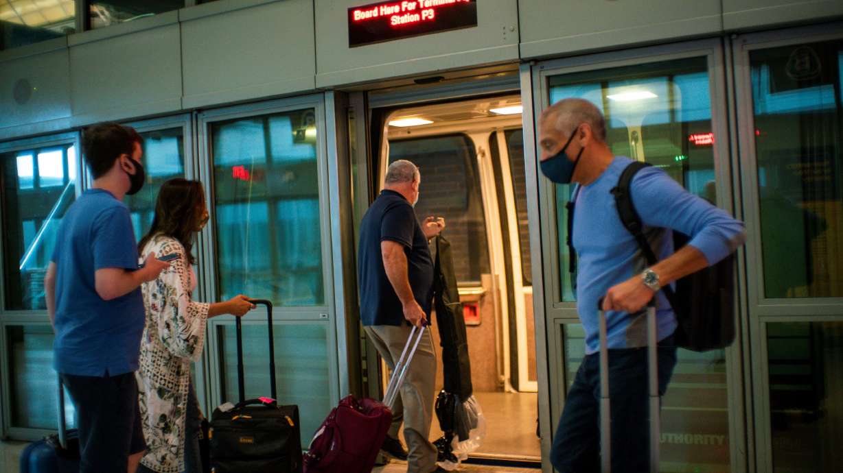 Travelers board the air train ahead of the July 4th holiday, at the Newark Liberty International Airport, in Newark, New Jersey, July 2, 2021.