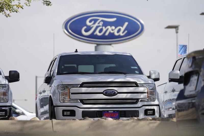In this Sunday, Oct. 11, 2020, photo, a row of 2020 sports-utility vehicles pickup trucks sit at a Ford dealership in Denver. Ford Motor Company said on Friday, July 16, it was recalling some Ford Explorer and F-350 models worldwide.