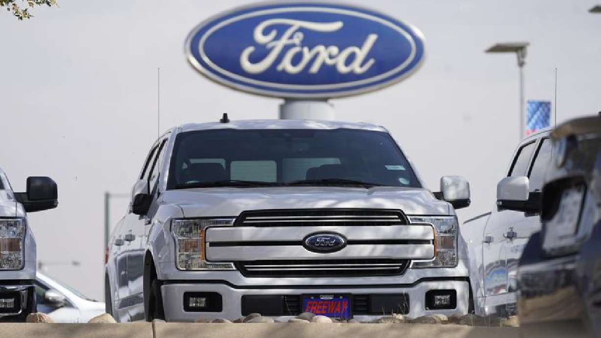 In this Sunday, Oct. 11, 2020, photo, a row of 2020 sports-utility vehicles pickup trucks sit at a Ford dealership in Denver. Ford Motor Company said on Friday, July 16, it was recalling some Ford Explorer and F-350 models worldwide.