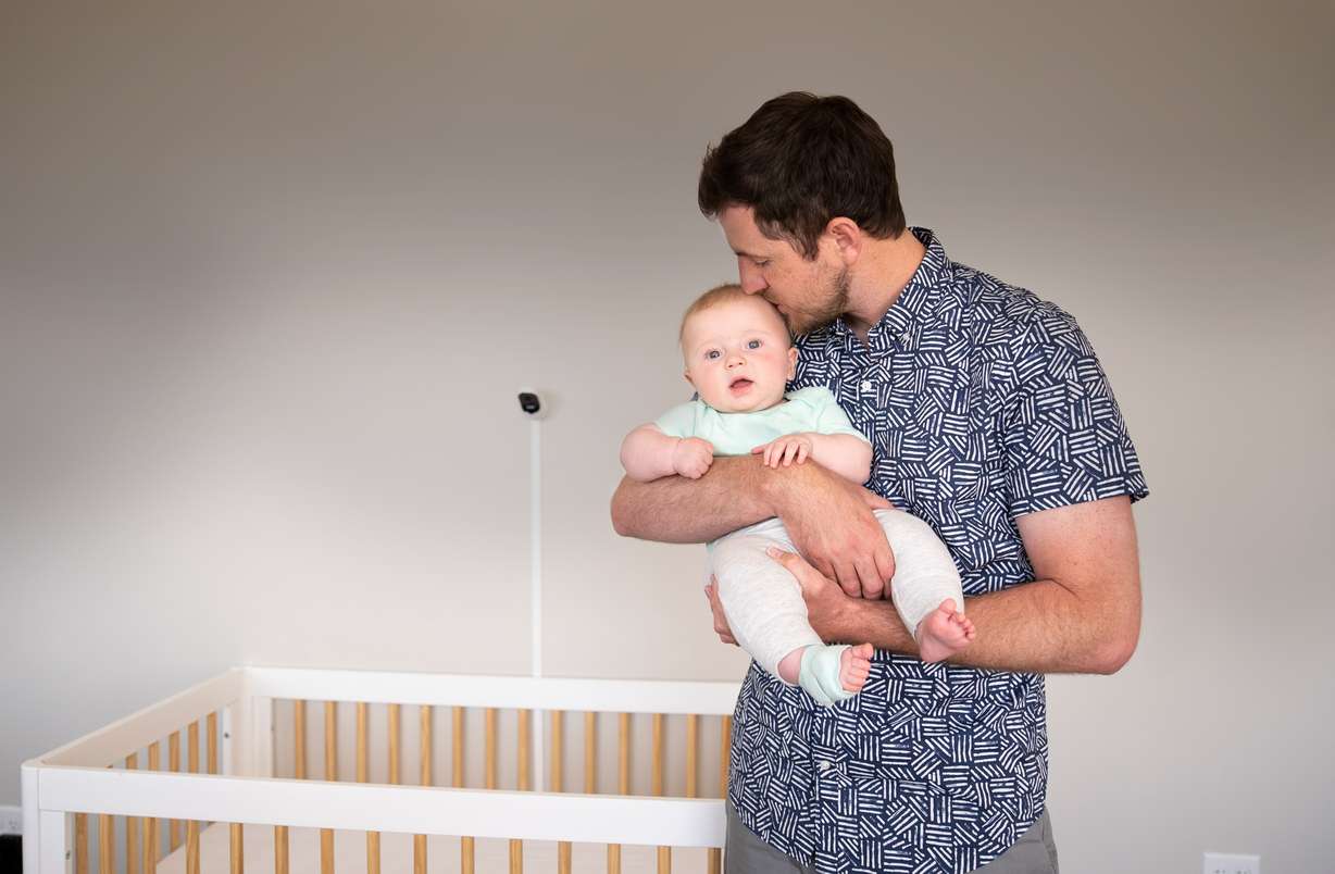 Owlet, Inc. CEO and co-founder Kurt Workman holds his youngest son, River. Workman started the company to monitor his children for possible congenital heart defects. Owlet made its debut on the New York Stock Exchange on Friday, July 16, 2021.