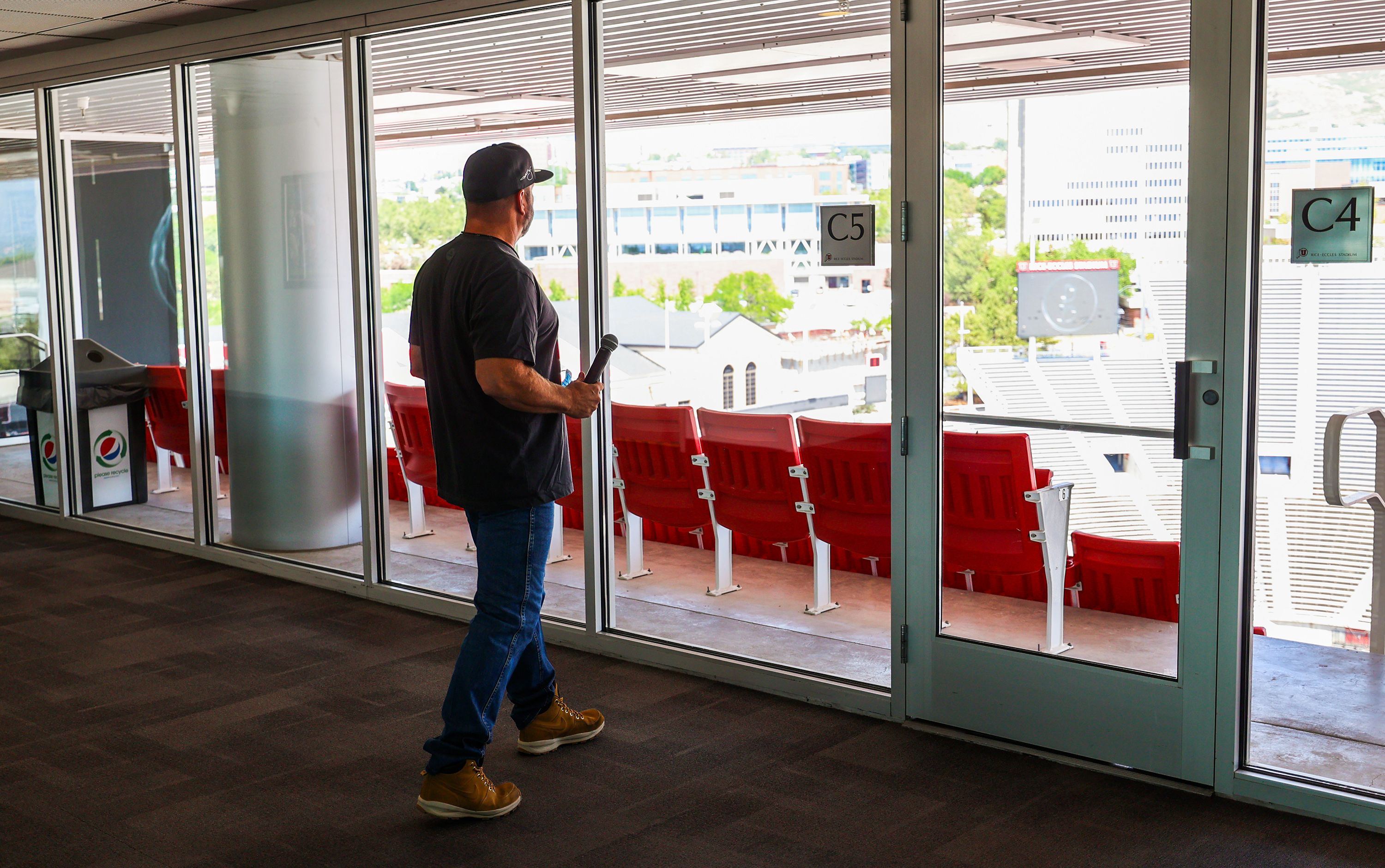 Country music superstar Garth Brooks walks over to the windows to look out over the stage setup before talking with members of the media during a press conference at the University of Utah's Rice-Eccles Stadium in Salt Lake City on Friday, July 16, 2021.