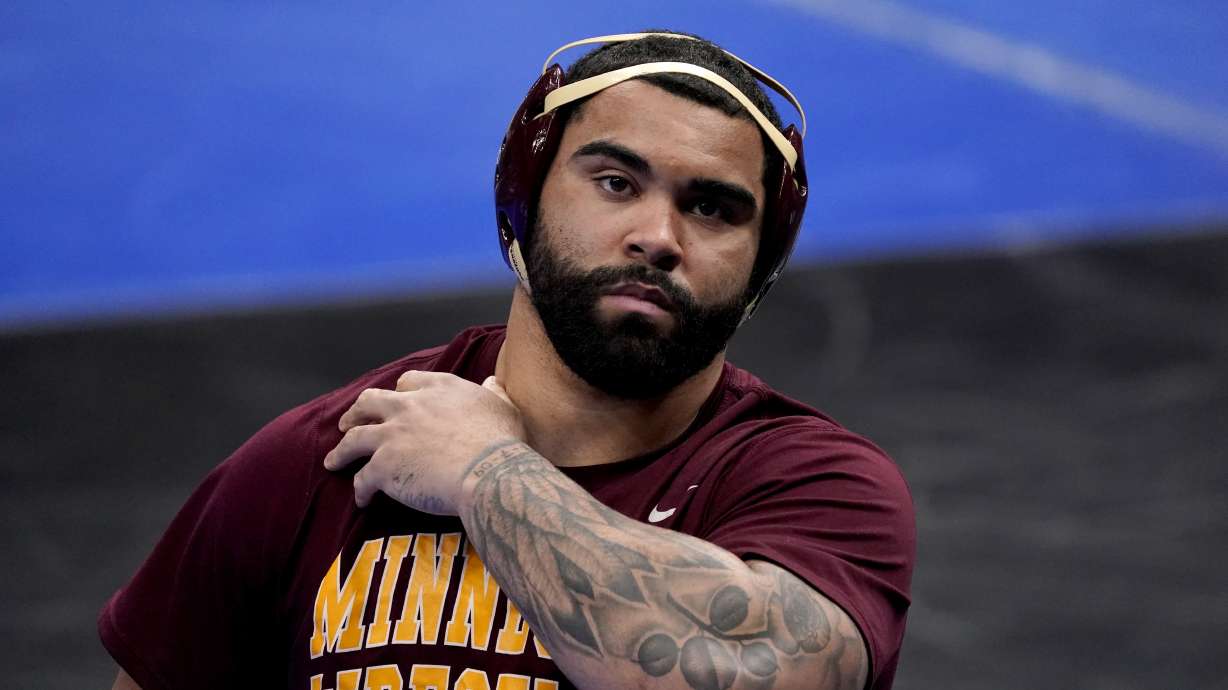 FILE - Minnesota's Gable Steveson prepares to take on Penn State's Greg Kerkvliet during their 285-pound match in the quarterfinal round of the NCAA wrestling championships in St. Louis, in this Friday, March 19, 2021, file photo. Steveson looks to become one of the youngest U.S. wrestling gold medalists ever when he competes at 125 kilograms in Tokyo. The charismatic 21-year-old hopes a successful run at the Games launches him into a WWE career like his mentor, Brock Lesnar, and an acting career like former WWE star Dwayne 'The Rock' Johnson.