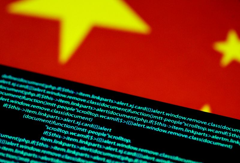 Computer code is seen on a screen above a Chinese flag in this July 12, 2017 illustration photo.
