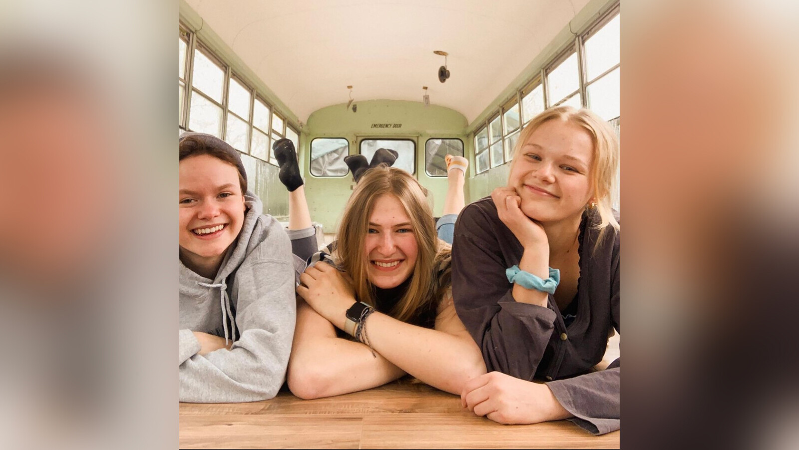 From left to right, Bekah King, Abi Roberts, and Morgan Tabor on the floor of their bus.