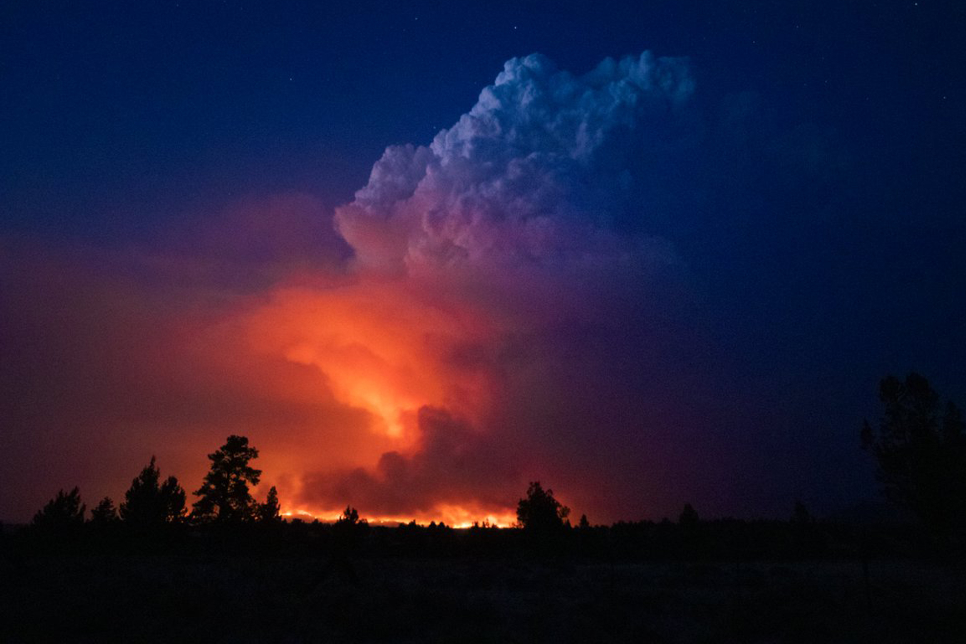 Flames and smoke rise from the Bootleg fire in southern Oregon on Wednesday, July 14, 2021. The largest fire in the U.S. on Wednesday was burning in southern Oregon.