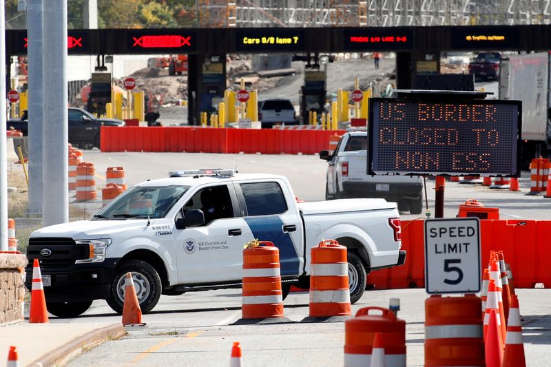 A U.S. Customs and Protection vehicle stands beside a sign reading that the border is closed to non-essential traffic at the Canada-United States border crossing at the Thousand Islands Bridge, to combat the spread of the coronavirus disease  in Lansdowne, Ontario, Canada September 28, 2020.