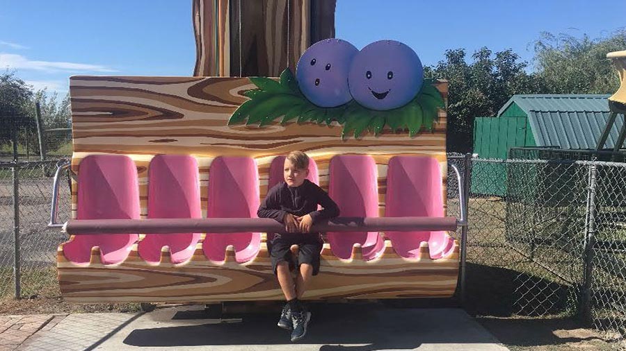 A photo from Lori's phone shows JJ Vallow sitting on a ride at Yellowstone Bear World just south of Rexburg on Sept. 14, 2019.