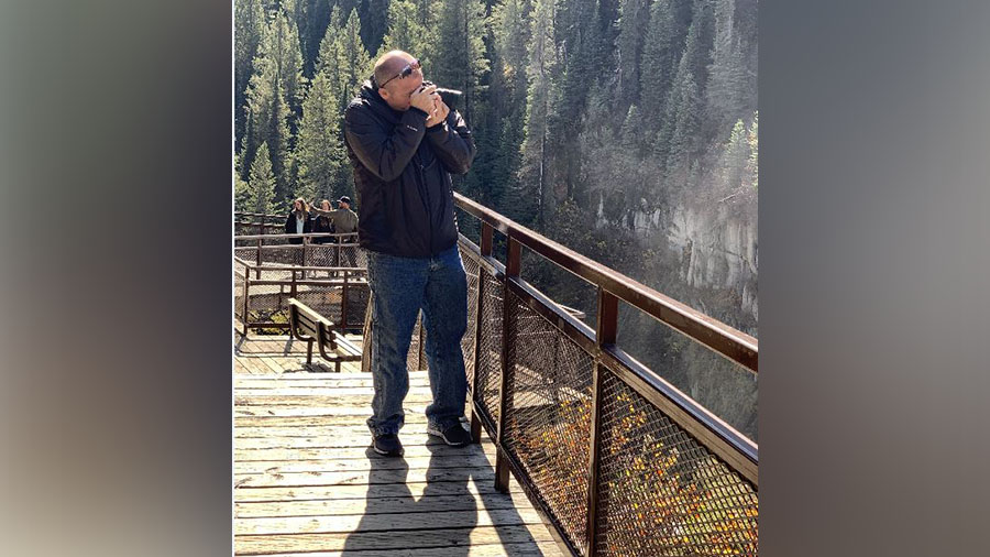 On Oct. 6, 2019, a photo shows Alex Cox taking pictures at Mesa Falls north of Rexburg, Idaho.